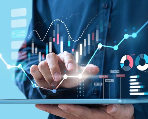 man-on-tablet-with-graphs-and-numbers-floating-above-the-tablet